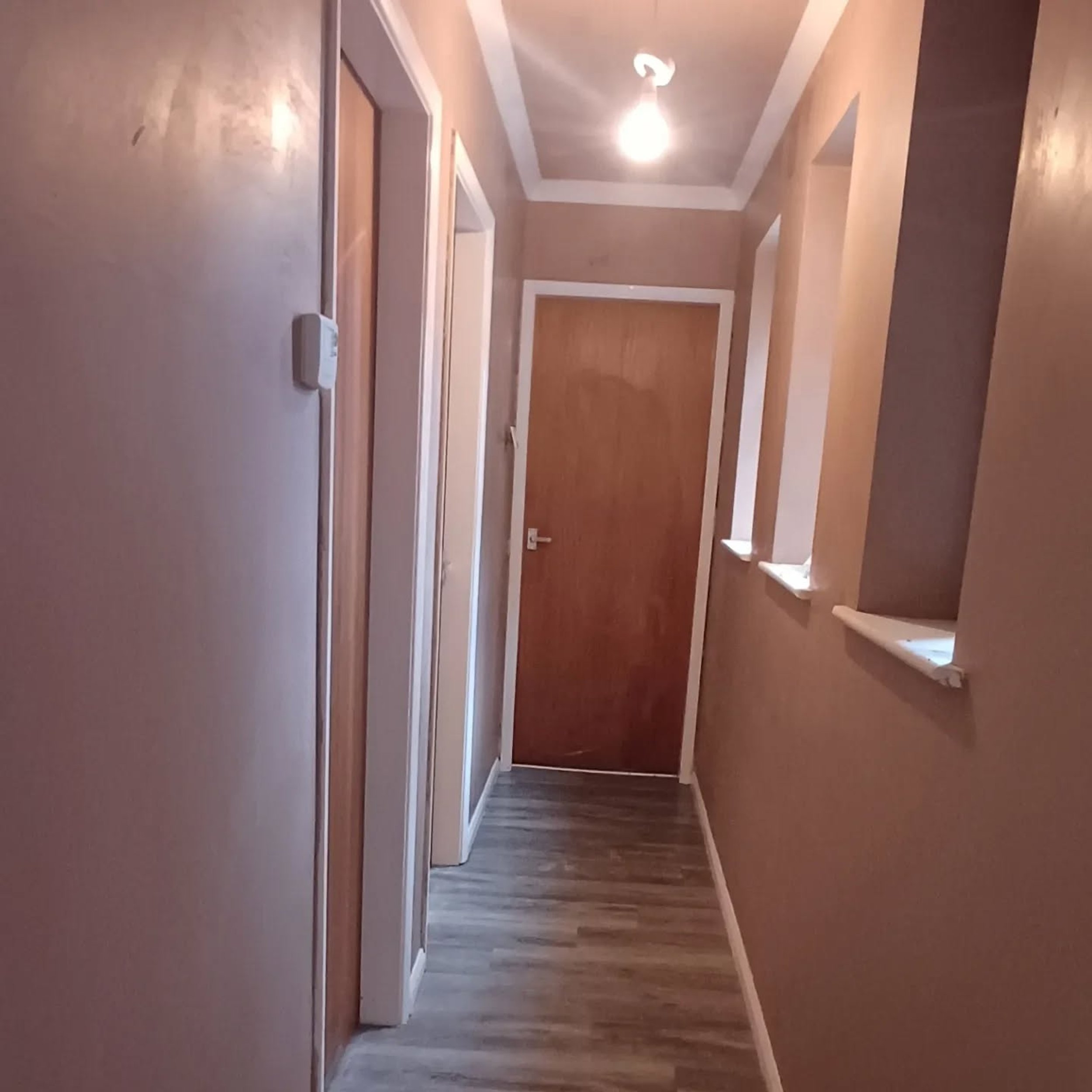 Hallway walls and ceiling freshly plastered by JB Plastering