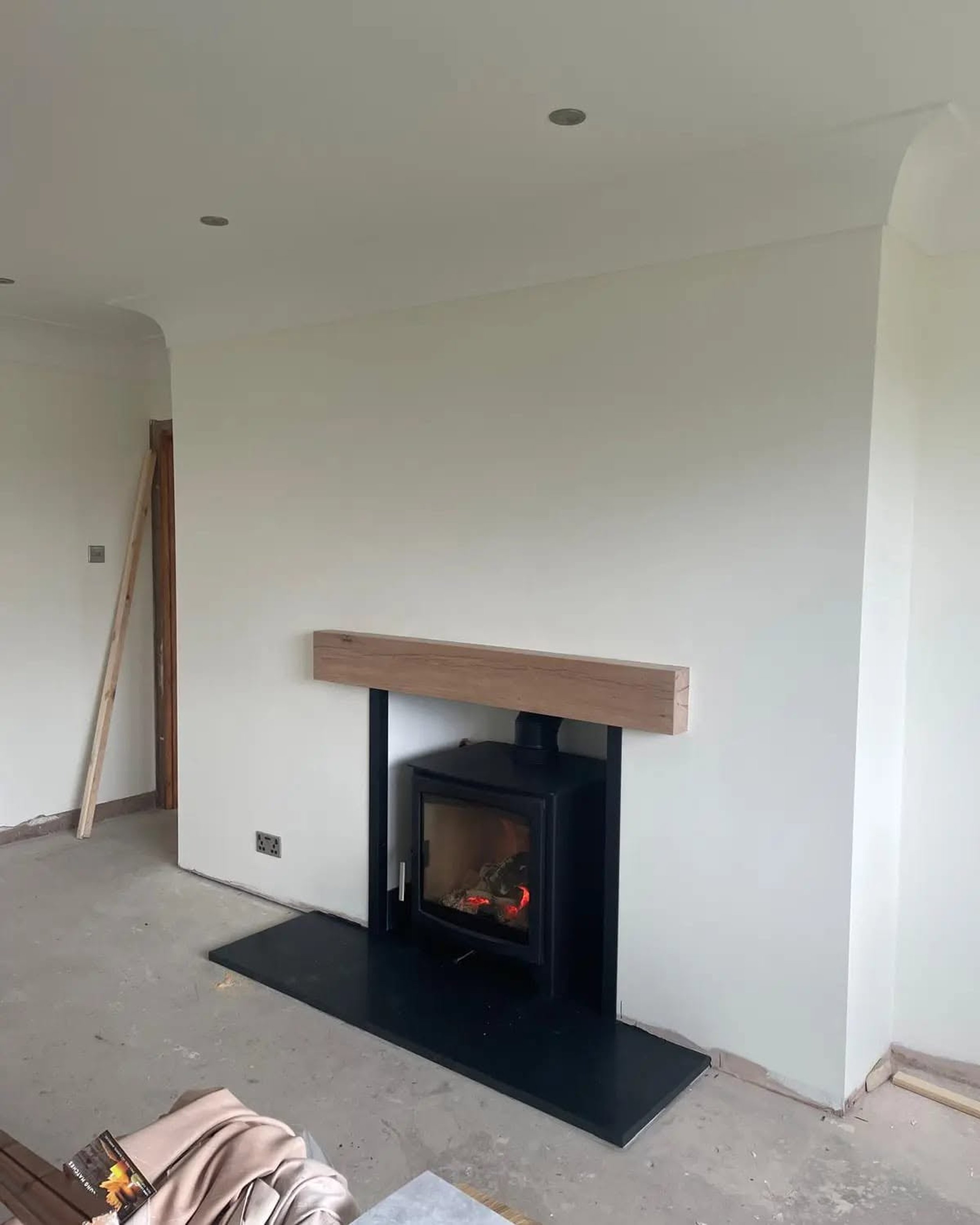 Living room plastered around a new log burner
